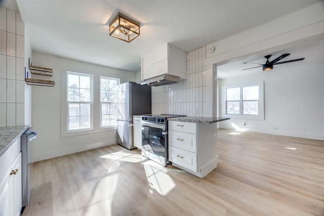 kitchen featuring light hardwood / wood-style floors, white cabinetry, stone counters, and stainless steel appliances