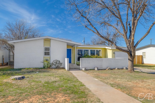 ranch-style house with a front lawn