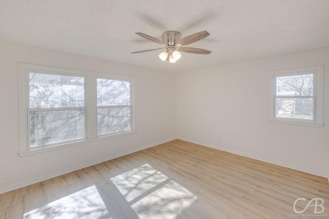 unfurnished room featuring ceiling fan, a textured ceiling, and light hardwood / wood-style floors