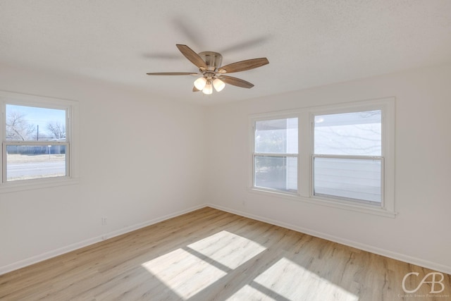 spare room with ceiling fan and light wood-type flooring