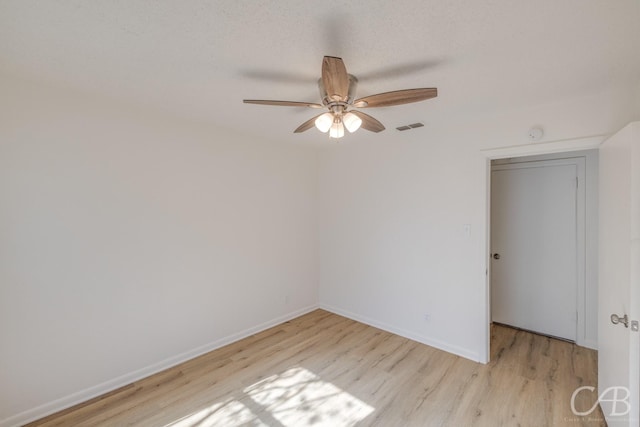 unfurnished room featuring ceiling fan, light hardwood / wood-style floors, and a textured ceiling