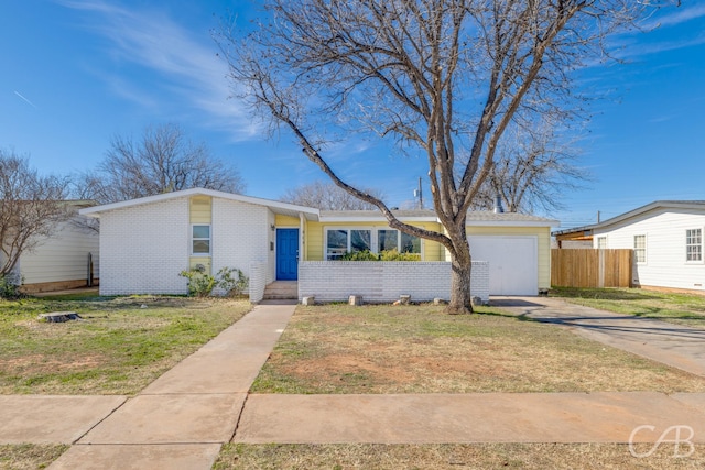 ranch-style home with a garage and a front yard