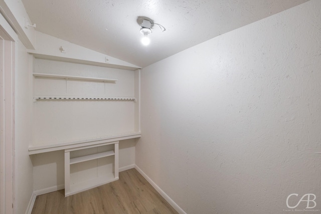 interior space with lofted ceiling and light hardwood / wood-style flooring