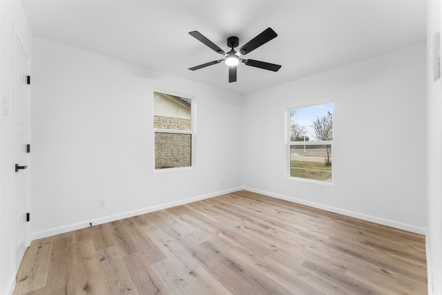 unfurnished room with light wood-style floors, a ceiling fan, and baseboards