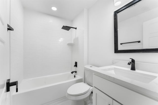 full bathroom featuring tiled shower / bath combo, toilet, and vanity