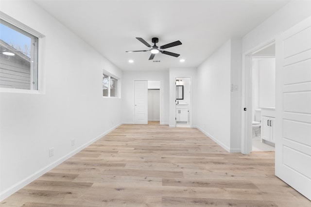 empty room with light wood-type flooring, ceiling fan, baseboards, and recessed lighting