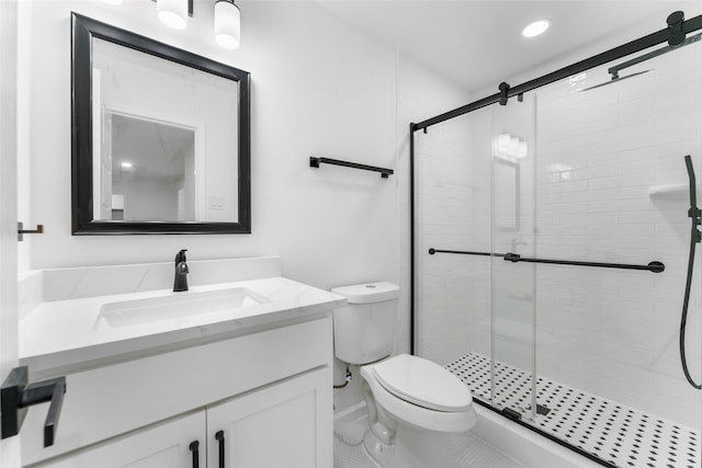 bathroom with vanity, toilet, a shower with door, and tile patterned flooring