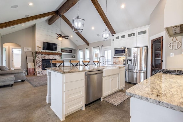 kitchen featuring a center island with sink, white cabinets, and appliances with stainless steel finishes