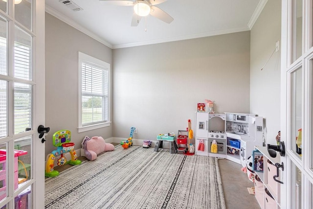 game room with ceiling fan and ornamental molding