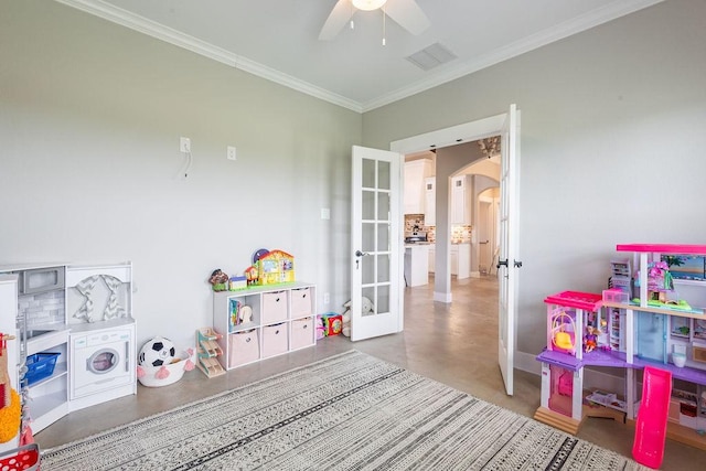 game room with ornamental molding, concrete floors, ceiling fan, and french doors