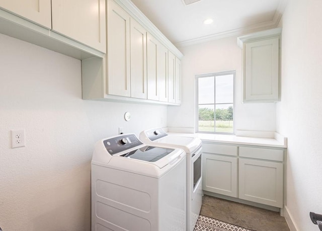 laundry room with washer and clothes dryer, crown molding, and cabinets