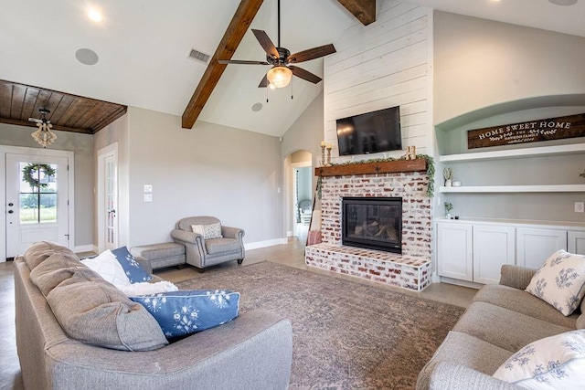 living room with built in features, high vaulted ceiling, beam ceiling, and a fireplace