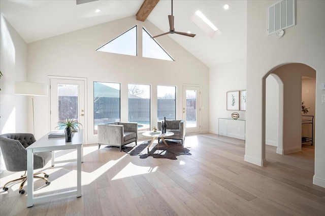 living room with beamed ceiling, ceiling fan, high vaulted ceiling, and light wood-type flooring