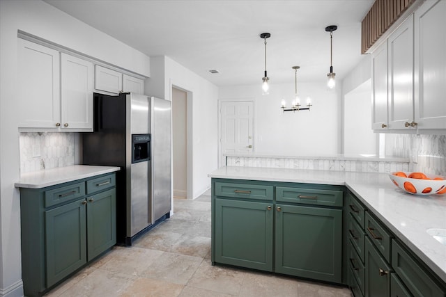 kitchen featuring white cabinetry, decorative light fixtures, and stainless steel fridge with ice dispenser