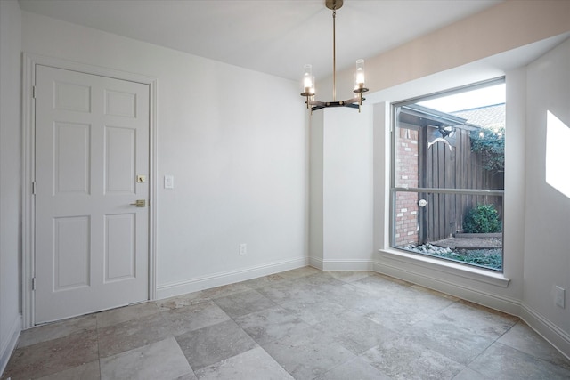 empty room featuring a notable chandelier