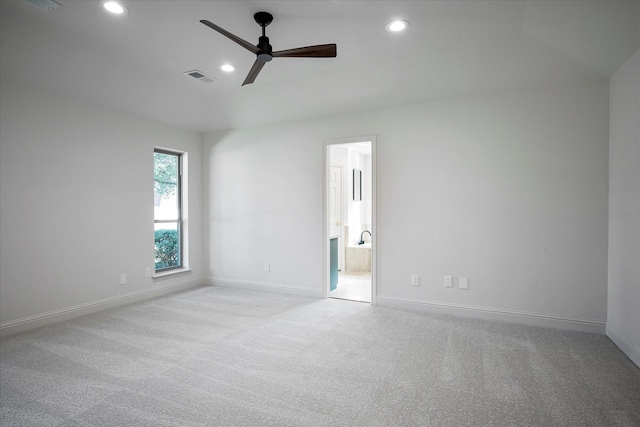 unfurnished room featuring light carpet and ceiling fan