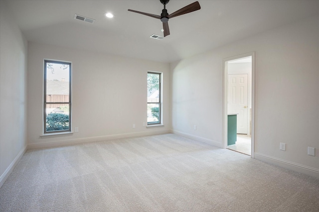 unfurnished room featuring plenty of natural light, light colored carpet, and ceiling fan