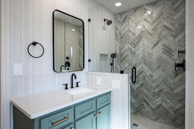 bathroom with vanity and a shower with shower door