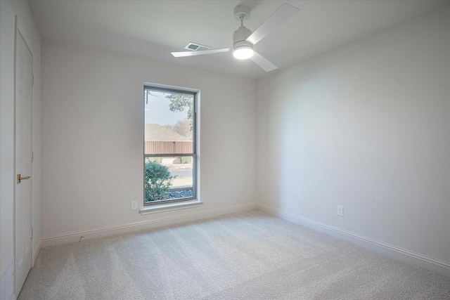 carpeted empty room featuring ceiling fan