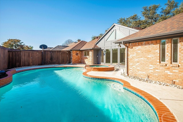 view of pool featuring an in ground hot tub