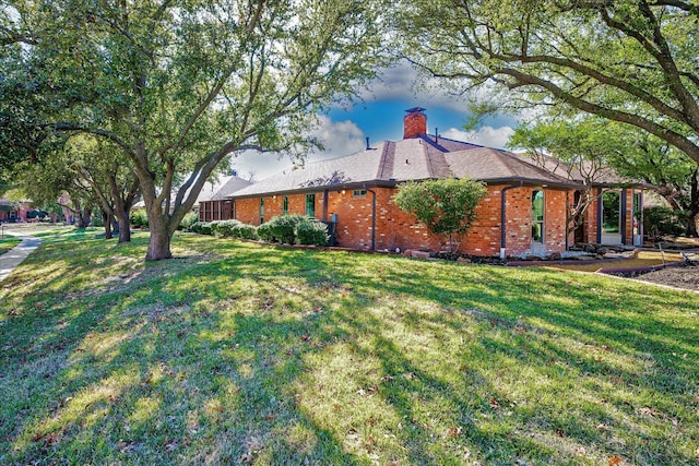 view of side of property with a yard