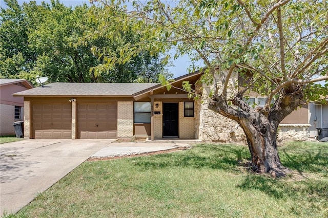 view of front of property with a garage and a front lawn