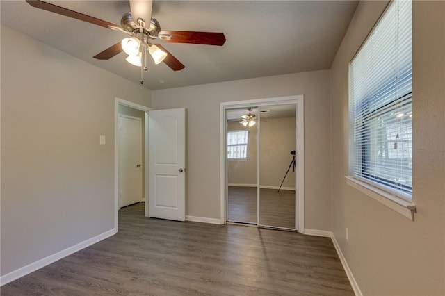 unfurnished bedroom featuring hardwood / wood-style flooring, a closet, and ceiling fan