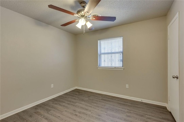 empty room featuring ceiling fan, hardwood / wood-style floors, and a textured ceiling