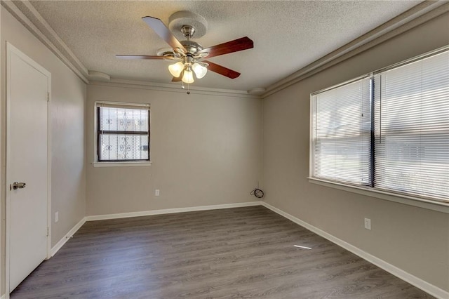 unfurnished room featuring ceiling fan, hardwood / wood-style floors, a textured ceiling, and crown molding