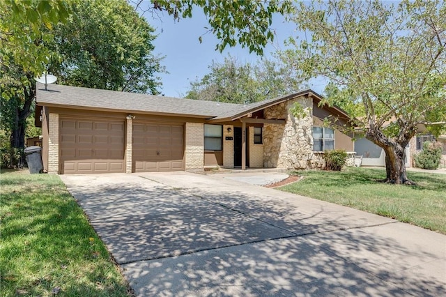 ranch-style house featuring a garage and a front lawn