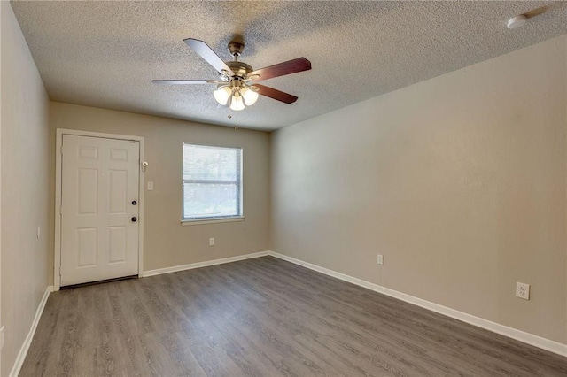 spare room featuring wood-type flooring, a textured ceiling, and ceiling fan