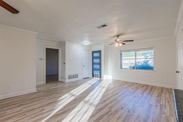 spare room featuring ceiling fan, crown molding, light hardwood / wood-style floors, and a textured ceiling