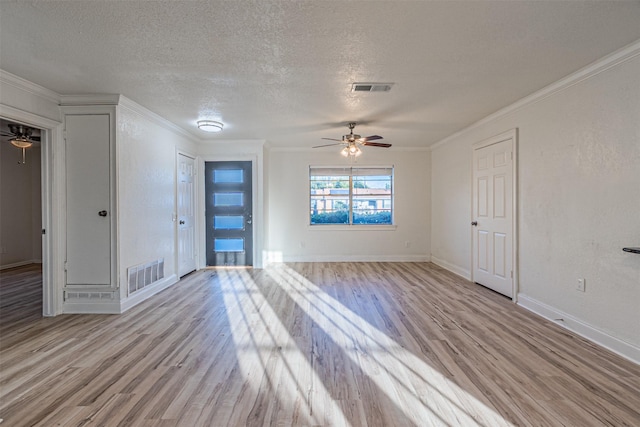 empty room with crown molding, light hardwood / wood-style floors, a textured ceiling, and ceiling fan