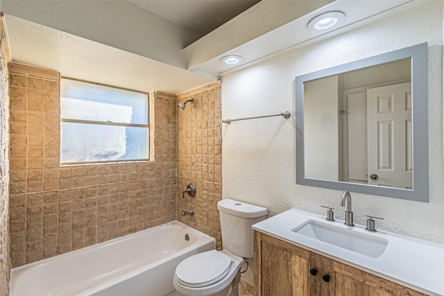 full bathroom featuring vanity, toilet, and tiled shower / bath