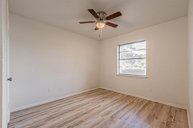 spare room with light wood-type flooring and ceiling fan