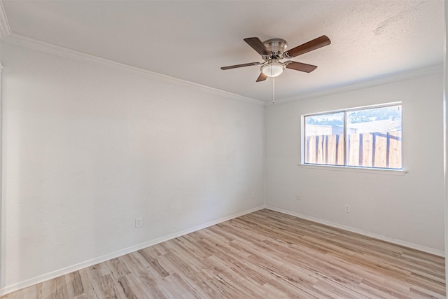 empty room with ceiling fan, light hardwood / wood-style flooring, a textured ceiling, and crown molding