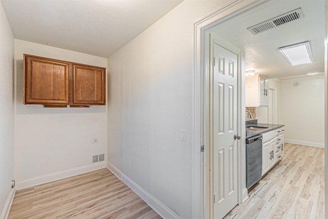 kitchen featuring light hardwood / wood-style floors, sink, and stainless steel dishwasher