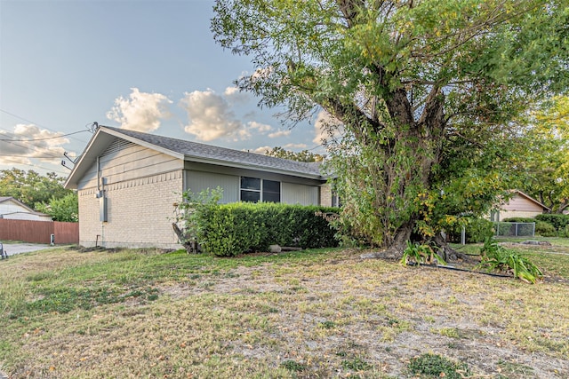 view of side of property with a lawn