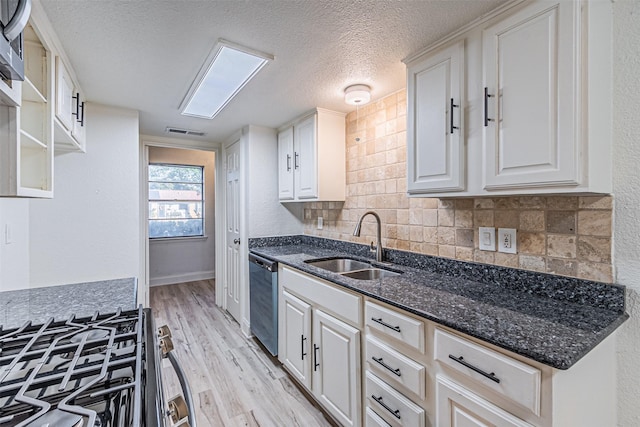 kitchen featuring sink, white cabinets, dark stone counters, and appliances with stainless steel finishes