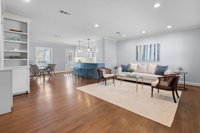 living room featuring ornamental molding and dark wood-type flooring