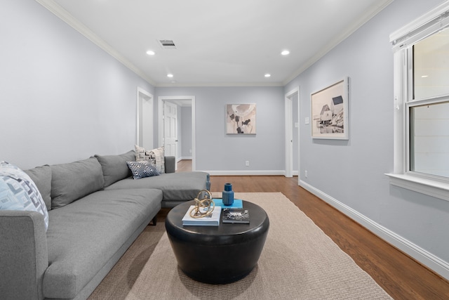 living room with crown molding and hardwood / wood-style flooring