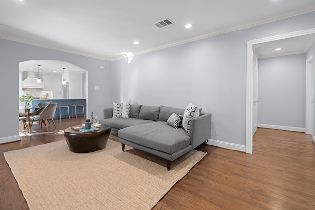 living room featuring ornamental molding and dark hardwood / wood-style floors