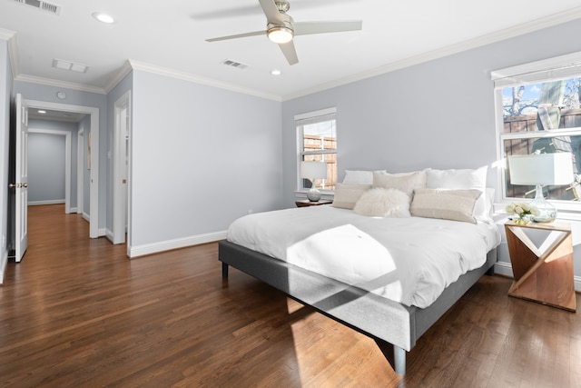 bedroom featuring crown molding, dark wood-type flooring, multiple windows, and ceiling fan