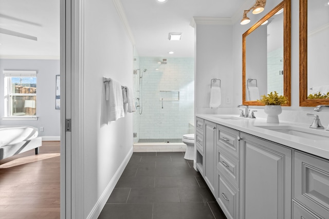 bathroom with a shower with shower door, tile patterned floors, vanity, and crown molding