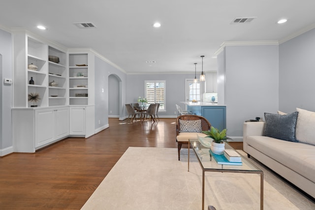 living room with dark hardwood / wood-style floors and crown molding