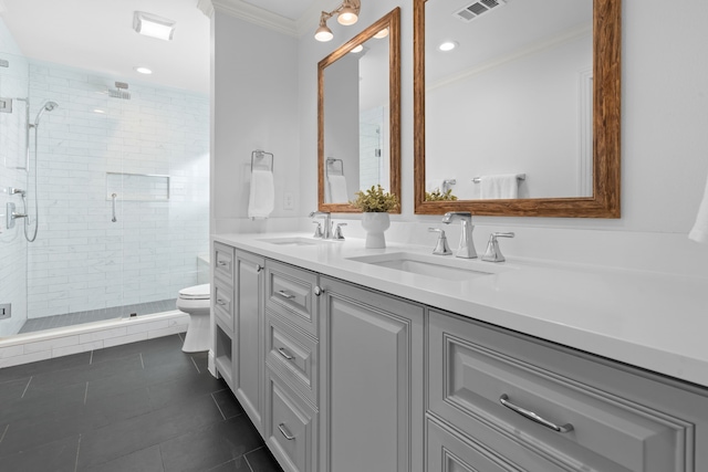 bathroom featuring toilet, crown molding, walk in shower, tile patterned flooring, and vanity