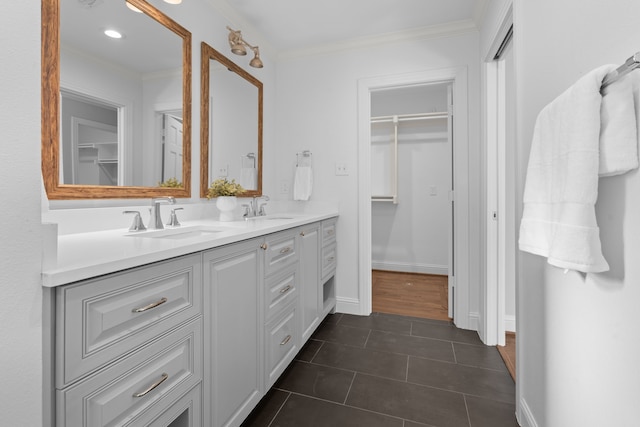 bathroom with vanity, ornamental molding, and tile patterned flooring