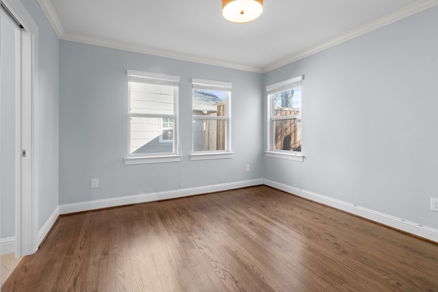 spare room featuring hardwood / wood-style flooring and ornamental molding