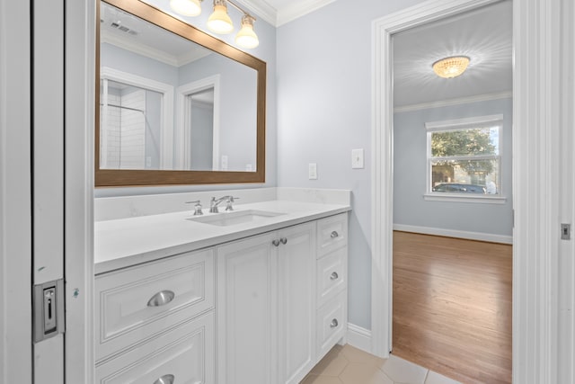 bathroom featuring vanity, crown molding, and tile patterned flooring