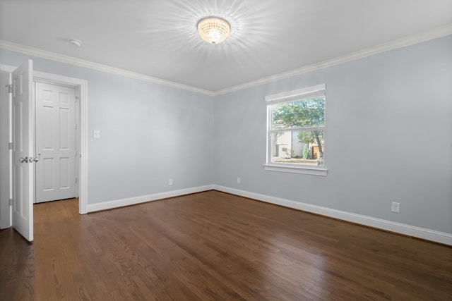 unfurnished room with crown molding and dark hardwood / wood-style flooring